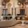 a large living room with a large chandelier and a couch