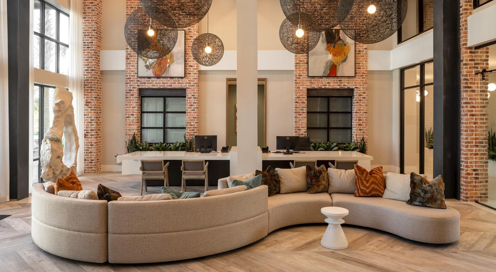 Settle into comfort at Vida Winter Garden a large living room with a large chandelier and a couch