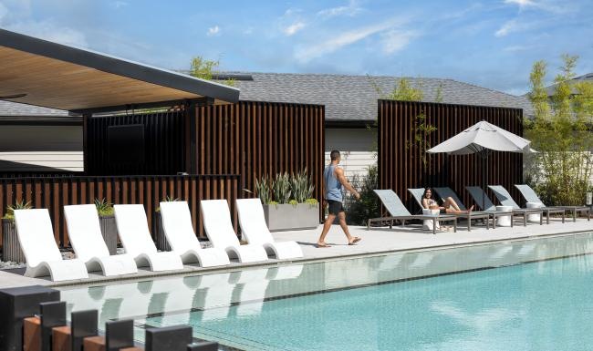 Relax and unwind poolside a person walking into a pool