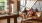 a couple of women sitting on a couch in a room with chandeliers and a table