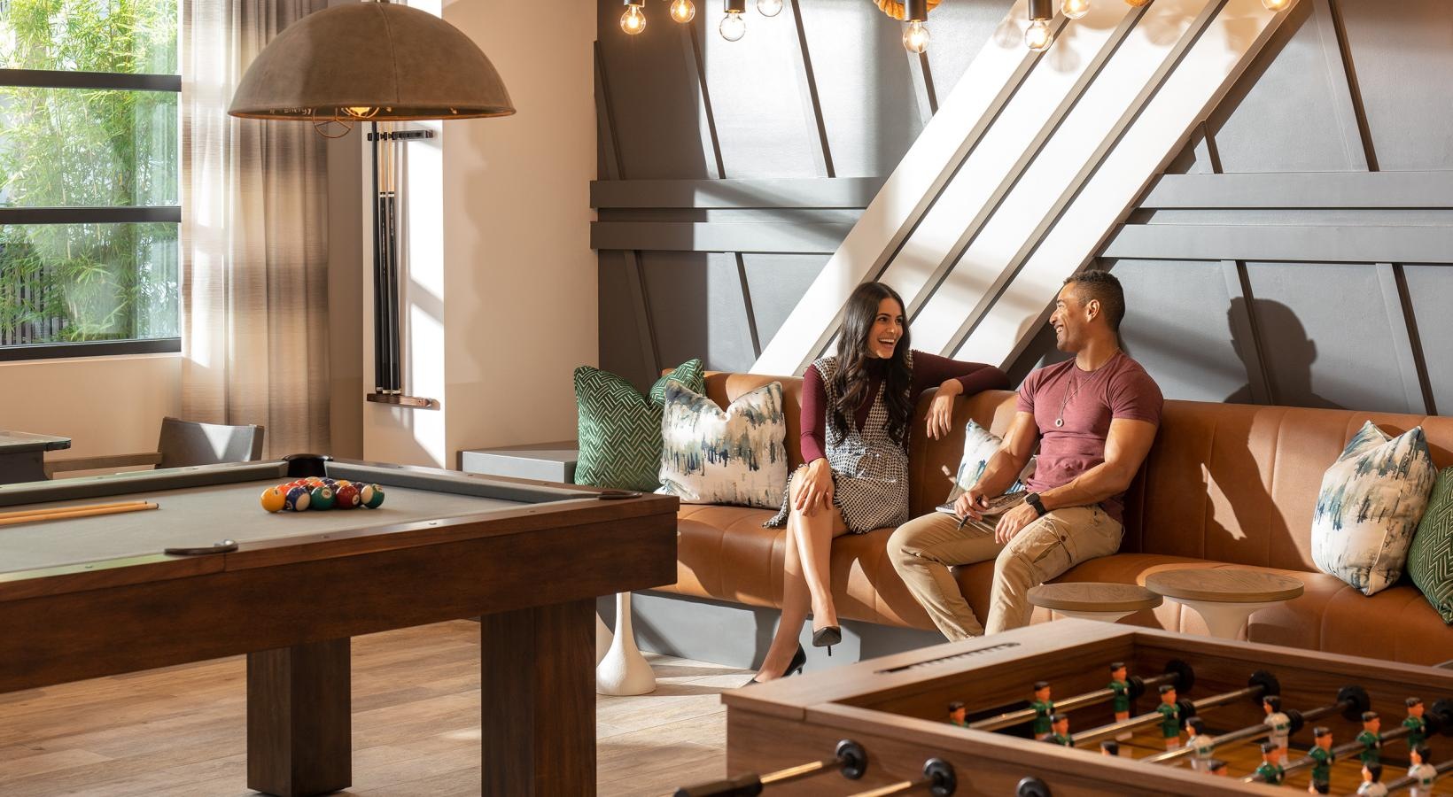 Find your perfect fit at Vida Winter Garden a couple of women sitting on a couch in a room with chandeliers and a table