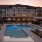 a swimming pool in front of a large building