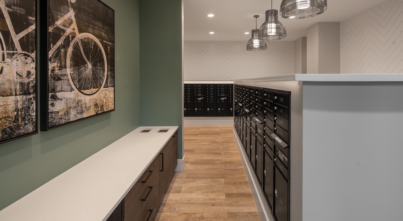 Find your perfect fit at Vida Winter Garden a room with a wood floor and a white counter with a black and white wall with art on