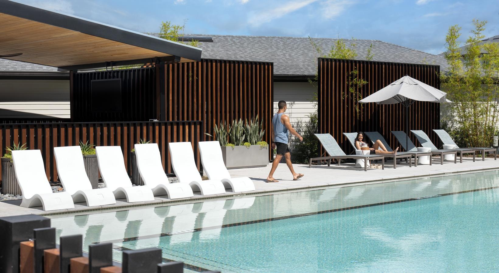 Relax and unwind poolside a person walking into a pool